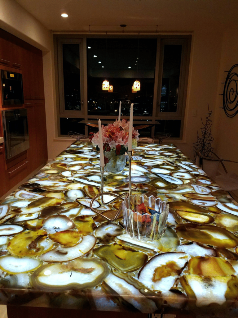 Backlit stone dining table in warm colors